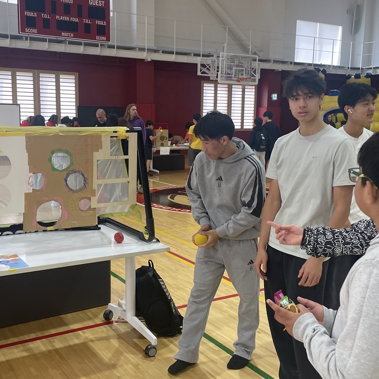 Students running the target shooting game